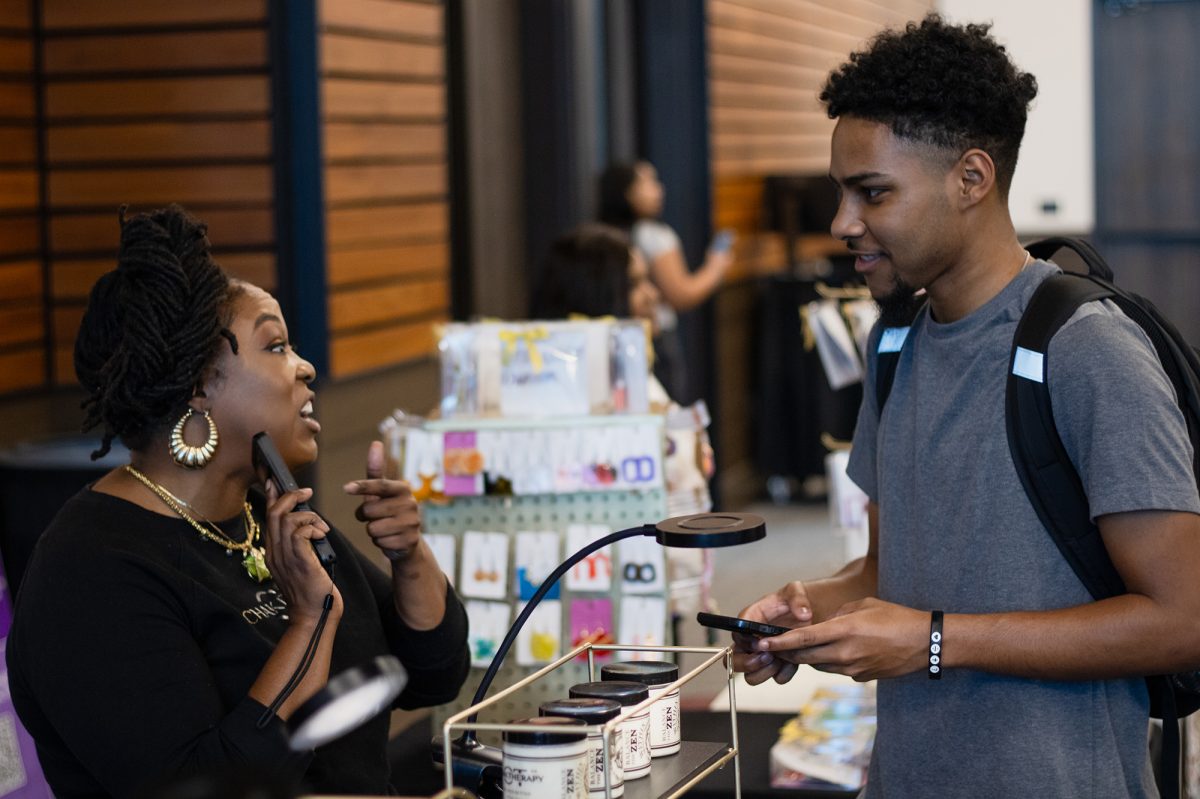 Mycheryl Russ tells mechanical engineering freshman Mante Brazil about her business Chak Therapy during the black history month kick off, Monday, Feb, 3, 2025, at the LBJ Student Center. Chak Therapy makes vegan products that are designed to honor the seven chakras while practicing self-care. 