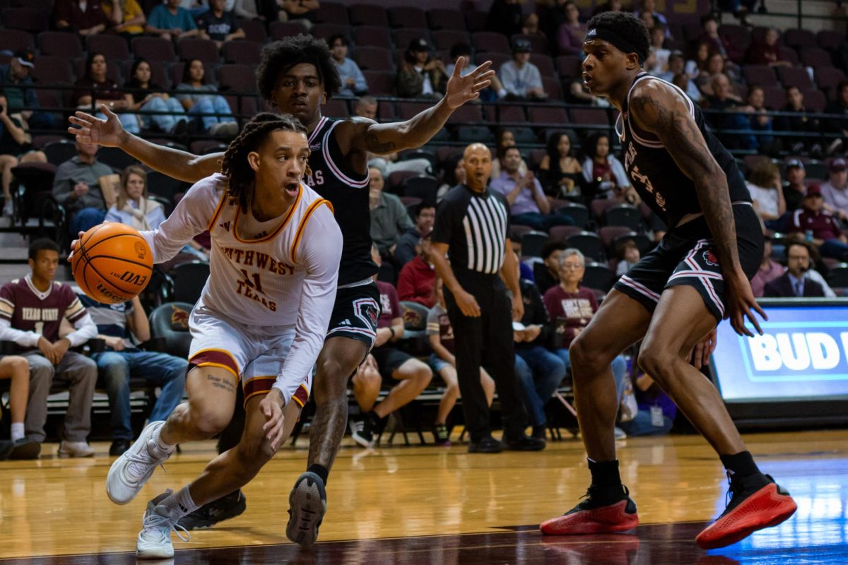 Sophomore guard Kaden Gumbs (11) dodges Arkansas State University players during the men's basketball game, Saturday, Feb. 1, 2025, at Strahan Arena.