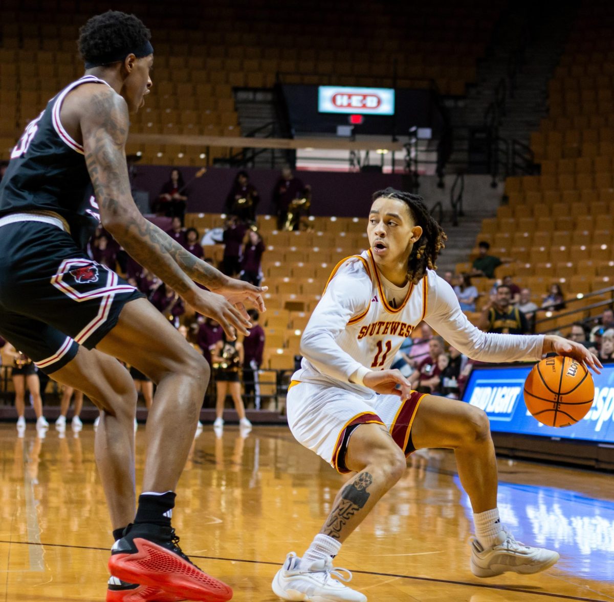 Texas State sophomore guard Kaden Gumbs (11) dodges an Arkansas State University player and looks for an opening to pass the ball during the men's basketball game, Saturday, Feb. 1, 2025, at Strahan Arena.