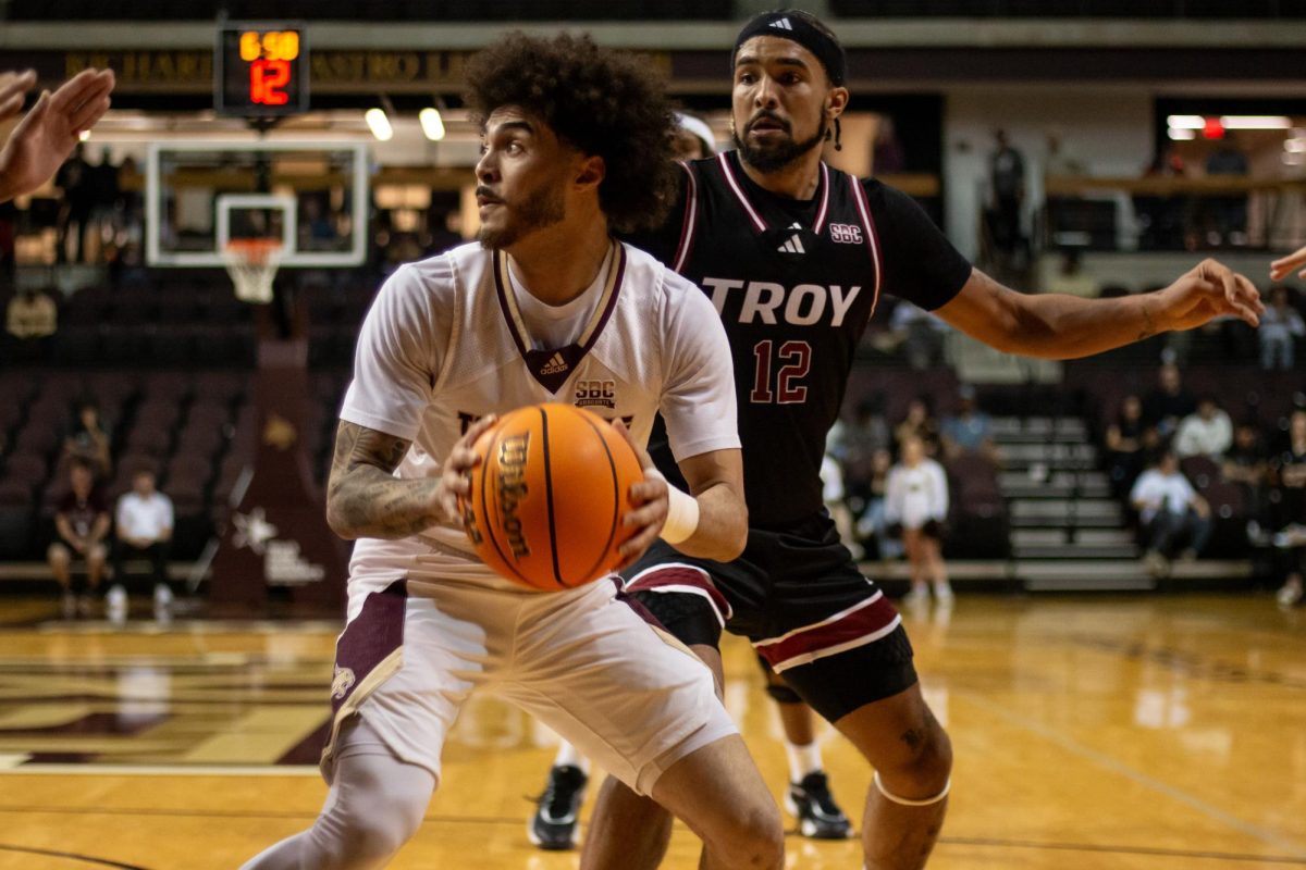 TXST graduate guard Drue Drinnon (55) looks past Troy University players for a teammate to pass the basketball to during the men's basketball game, Tuesday, Feb. 25, 2025, at Strahan Arena. Texas State lost the game 74-69.