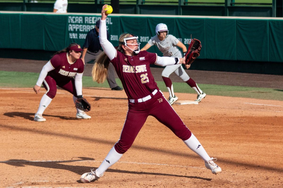 TXST junior pitcher Emma Strood (25) reaches to begin a pitch during the softball game against Fordham University, Saturday, Feb. 15, 2025, at the Softball Complex. TXST won the game 8-0.