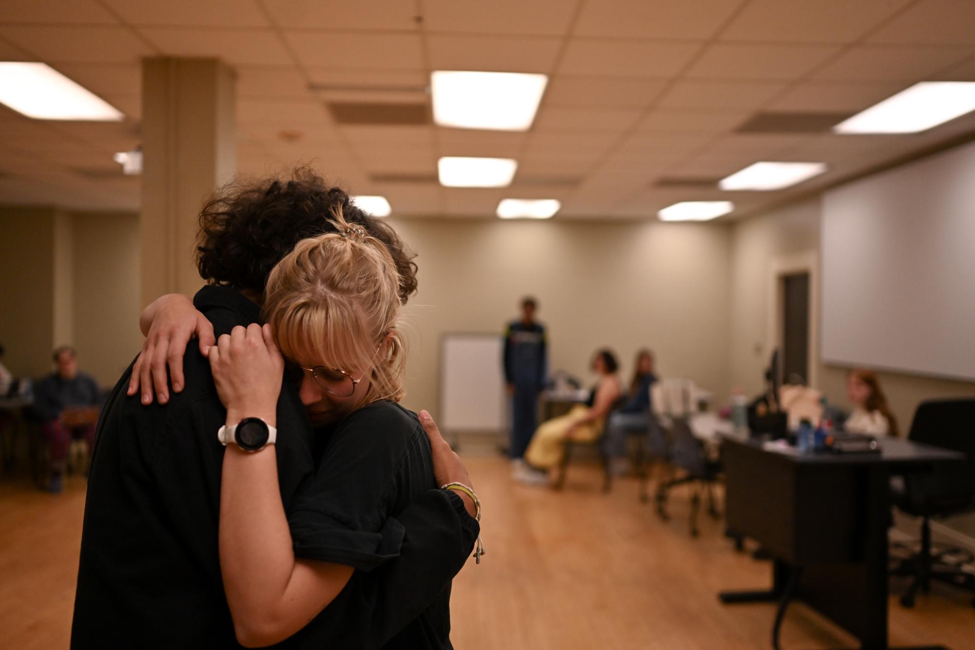 Freshman Andrew Tapia and Senior Amelia Hobson embrace one another during a run through of "Karagula"on Thursday, February 21 at the honors college. "Karagula" written by Phillip Ridley, is being directed by Abigail Thompson as part of her honors capstone project.