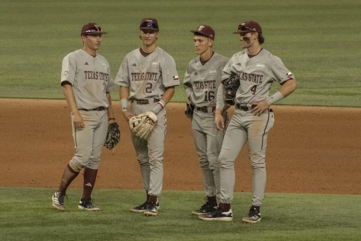 Texas State infielders Ryne Farber (3), Chase Mora (2), Dawson Park (16) and Cameron Thompson (4) wait for play to resume in the game against No. 19 Oklahoma State on Tuesday, Feb. 18, 2025, at Globe Life Field in Arlington. Bobcats won 4-2.