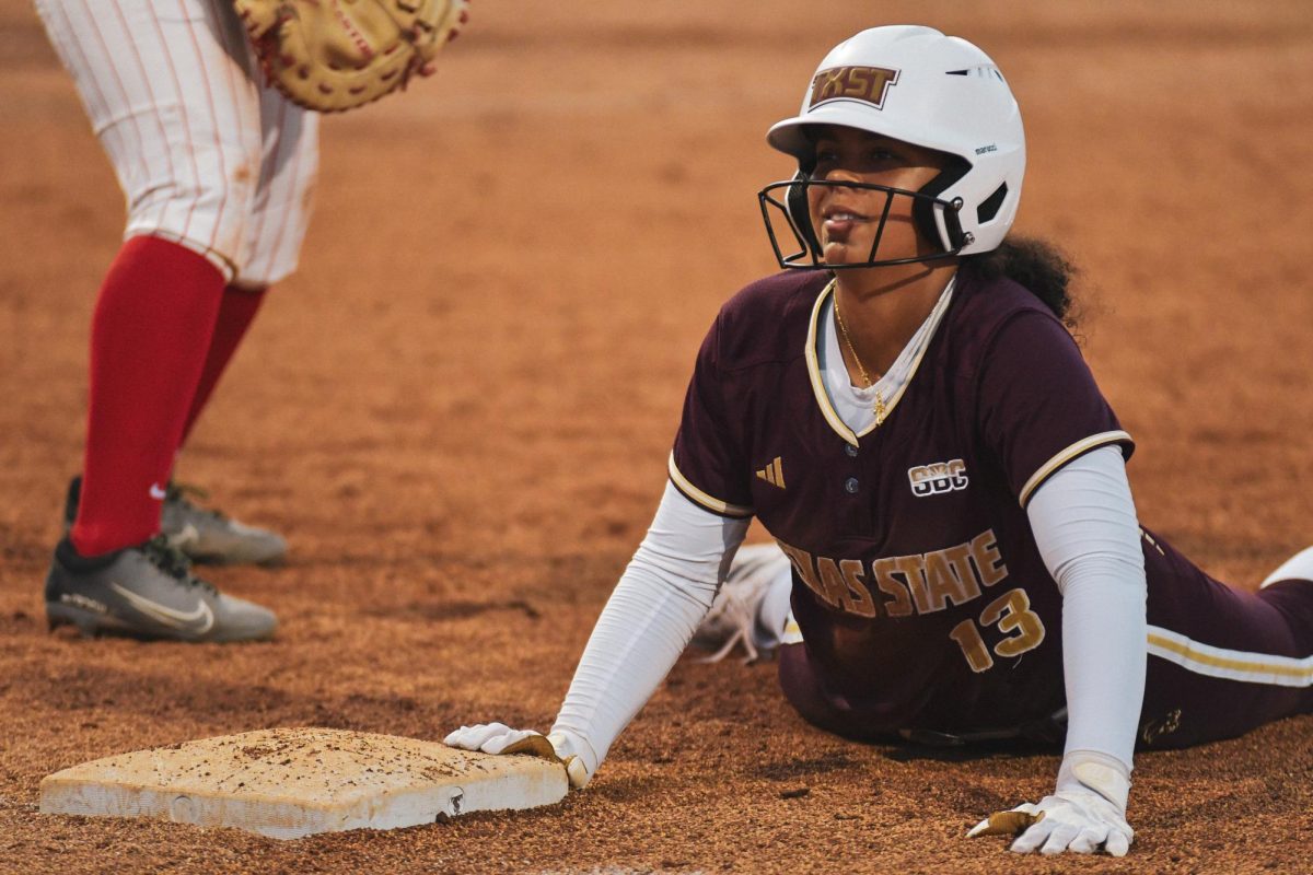 Texas State junior outfielder Keely Williams (13) slides into first base against New Mexico on Saturday, Feb. 15, 2025, at Bobcat Ballpark.