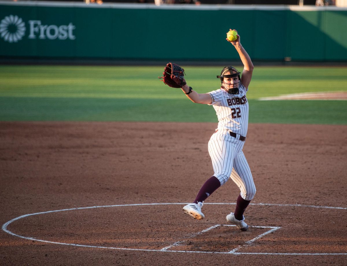 Texas State sophomore Maddy Azua throws a pitch at the game against Arkansas State University on Feb. 6, 2025.