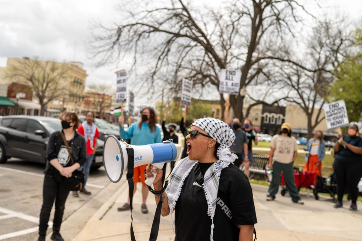 San Marcos city council member Amanda Rodriguez leads a chant at the Stop The Genocide protest in downtown San Marcos on Sunday, March 23. The protest was held in collaboration between the Palestine Solidarity SMTX chapter and the Party for Socialism and Liberation San Marcos chapter.