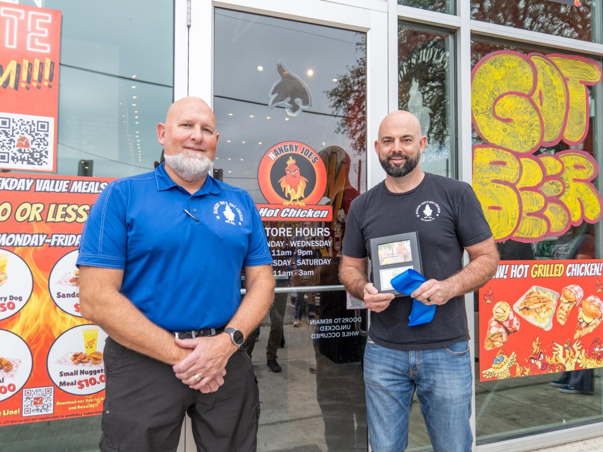 Co-owners of Hangry Joe's David Thompson (left) and Brandon Wilhelm (right) pose outside of the store during the ribbon cutting ceremony on February 6th, 2025. 