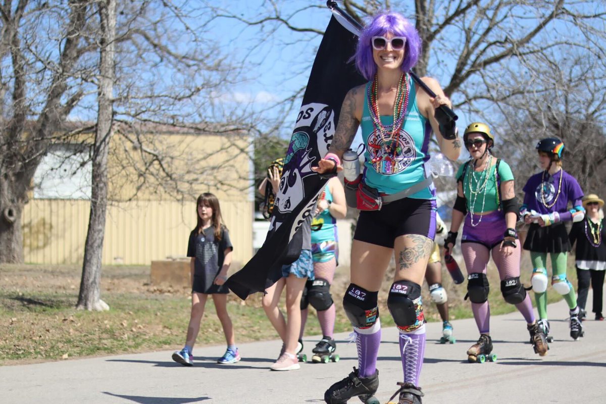 Rebecca Hudson aka Strawberry STOMPcake a member of the San Marcos River Rollers, roller-skates in the the Mistick Krewe of Okeanos Mardi Gras Parade, Saturday, March 1, 2025, in San Marcos. The San Marcos River Rollers are a local all female roller-derby team.
