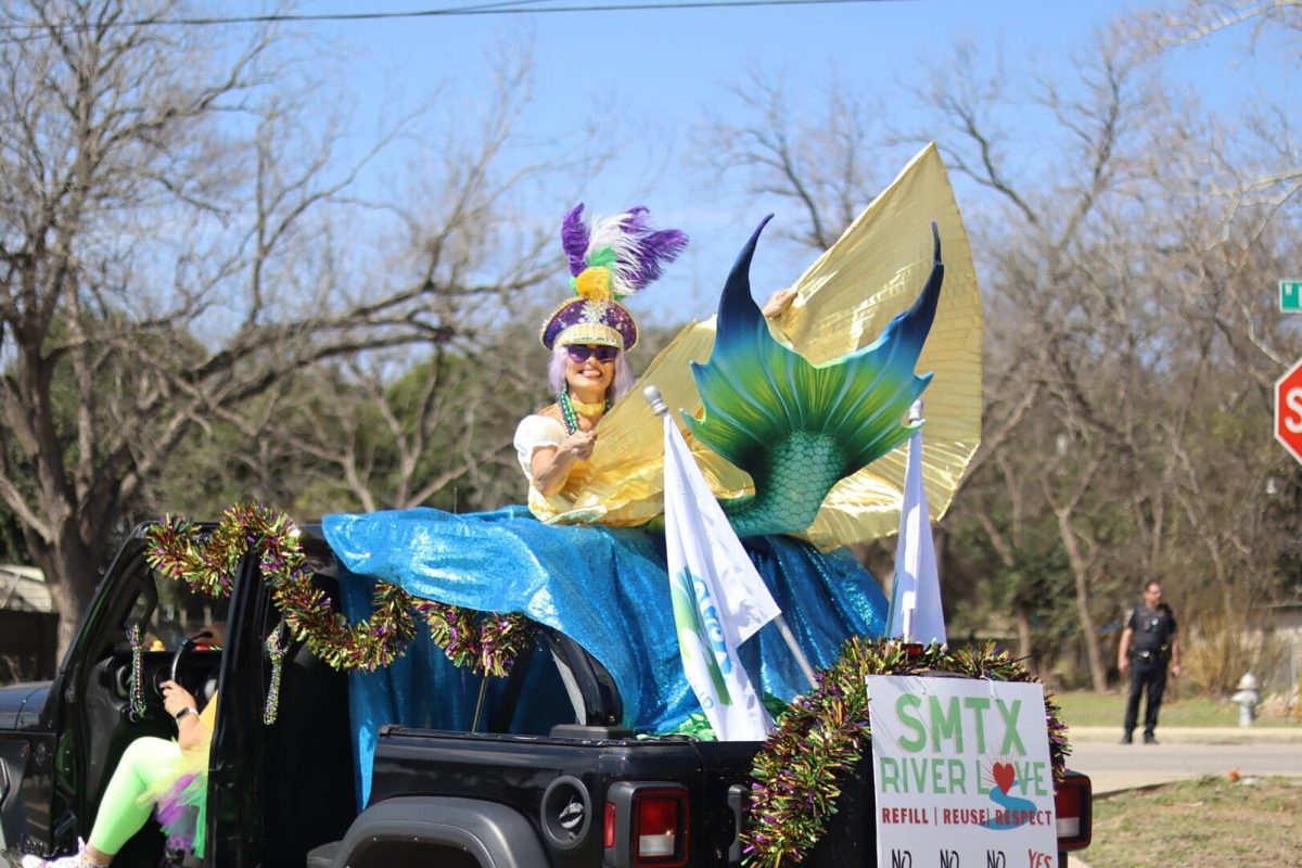 Laura Cardona, the AquaReina Executive Team Leader of the Mermaid Society of Texas rides in a float dressed as a mermaid during the Mistick Krewe of Okeanos Mardi Gras Parade, Saturday, March 1, 2025, in San Marcos. The Mermaid Society celebrates and preserves the San Marcos River.