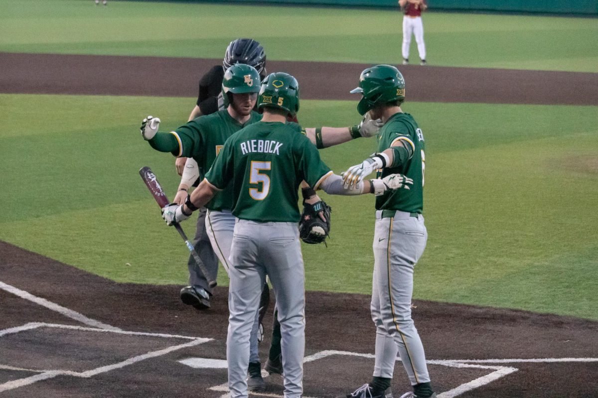 Baylor senior designated hitter Wesley Jordan (33) is embraced by his teammates freshman third baseman Pearson Riebock (5) and sophomore second baseman Travis Sanders (6) after hitting a home run, March 18, 2025, at Bobcat Ballpark. The Bobcats were defeated by Baylor in the seventh inning 19-3.