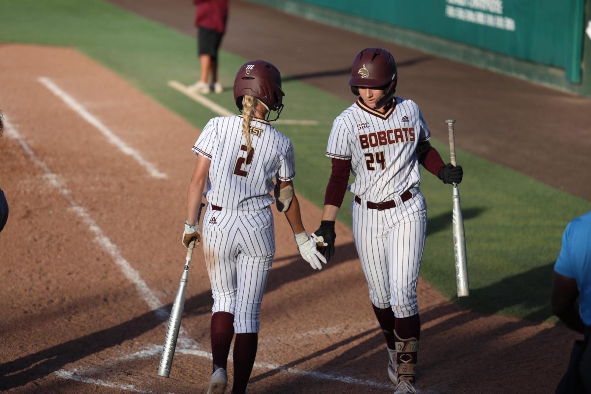 Texas State freshman infielder Erin Peterson (2) dapping up sophomore infielder Kate Bubela (24) against Wichita State, Wednesday, March 19th, 2025 at Bobcat Softball Stadium.