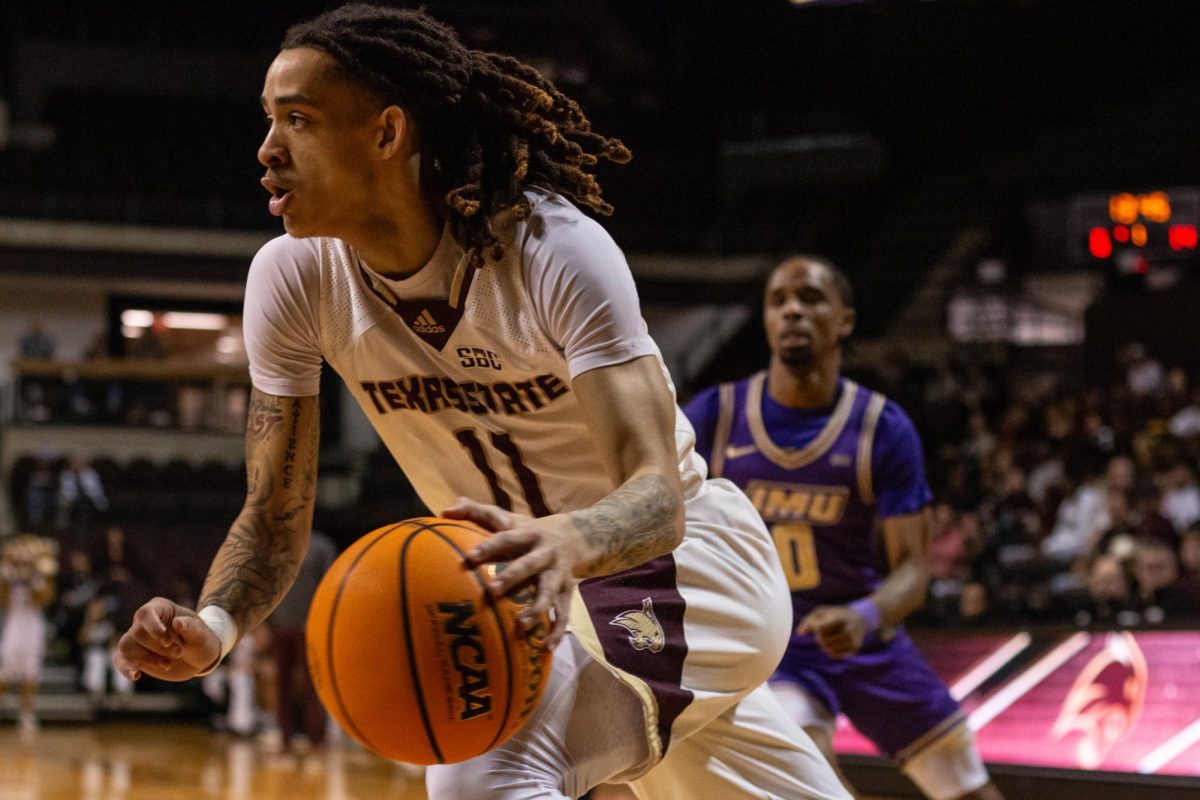 TXST sophomore guard Kaden Gumbs (11) rushes the basketball towards the basket during the men's basketball game against James Madison University, Friday, Feb. 28, 2025, at Strahan Arena. Texas State won 102-93 in double overtime.