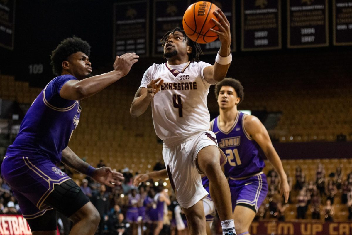 TXST junior guard Mark Drone (4) attempts a layup during the men's basketball game against James Madison University, Friday, Feb. 28, 2025, at Strahan Arena. Texas State won the game 102-93 in double-overtime.