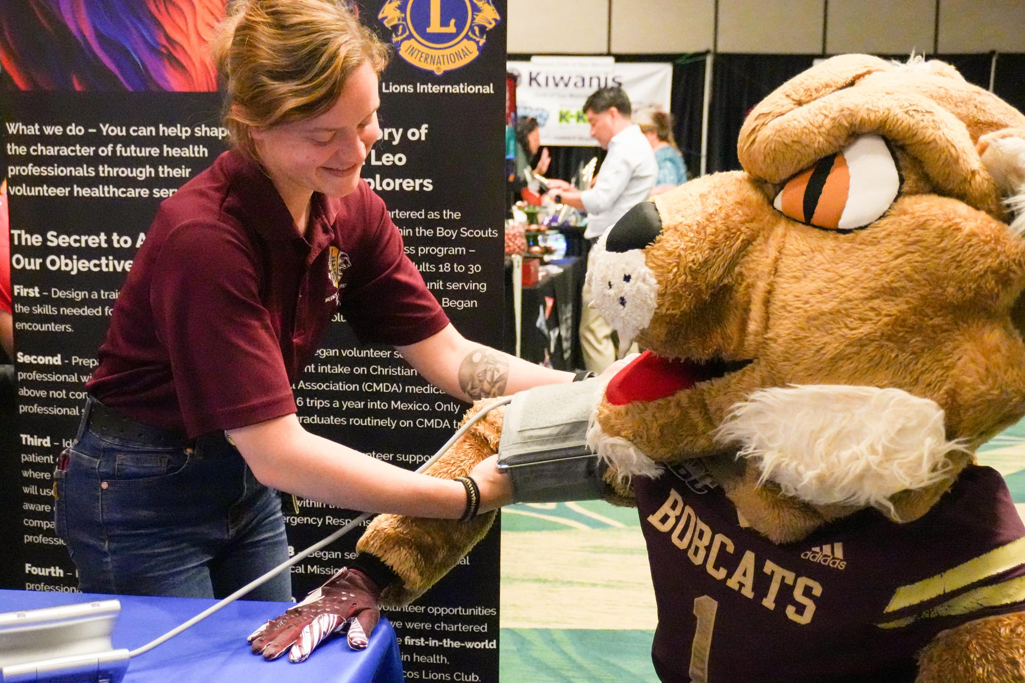 Charlotte Lund (Left) receives a special show edition of the San Marcos Daily Record newspaper from media account executive Jacob Jones (Right) during the Business Showcase, Thursday, Aug. 28, 2025, at the Embassy Suites Conference Center.