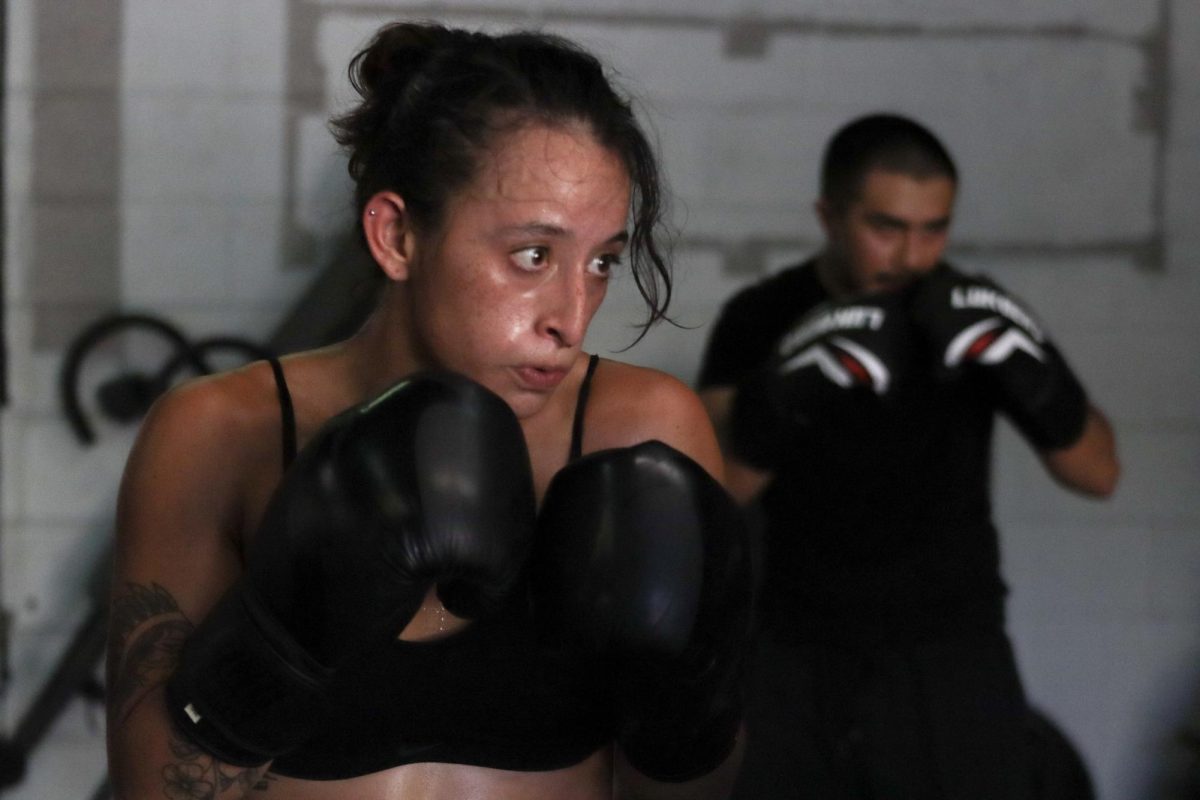 Texas State animal science junior Maite Curiel spars off with a partner during open gym practice Friday, Sept. 19, 2025, at the SMASH MMA gym.