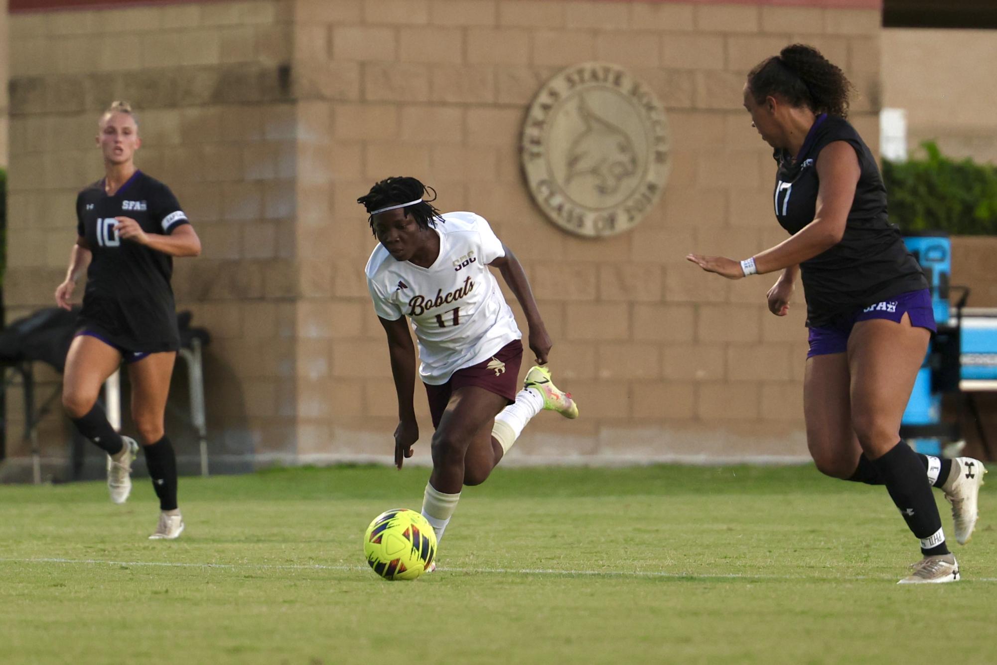 Texas State junior forward Constance Agyemang (17) aggressively dribbling towards Stephen F. Austin's goal, 28 Aug., 2025, at Bobcat Soccer Complex.