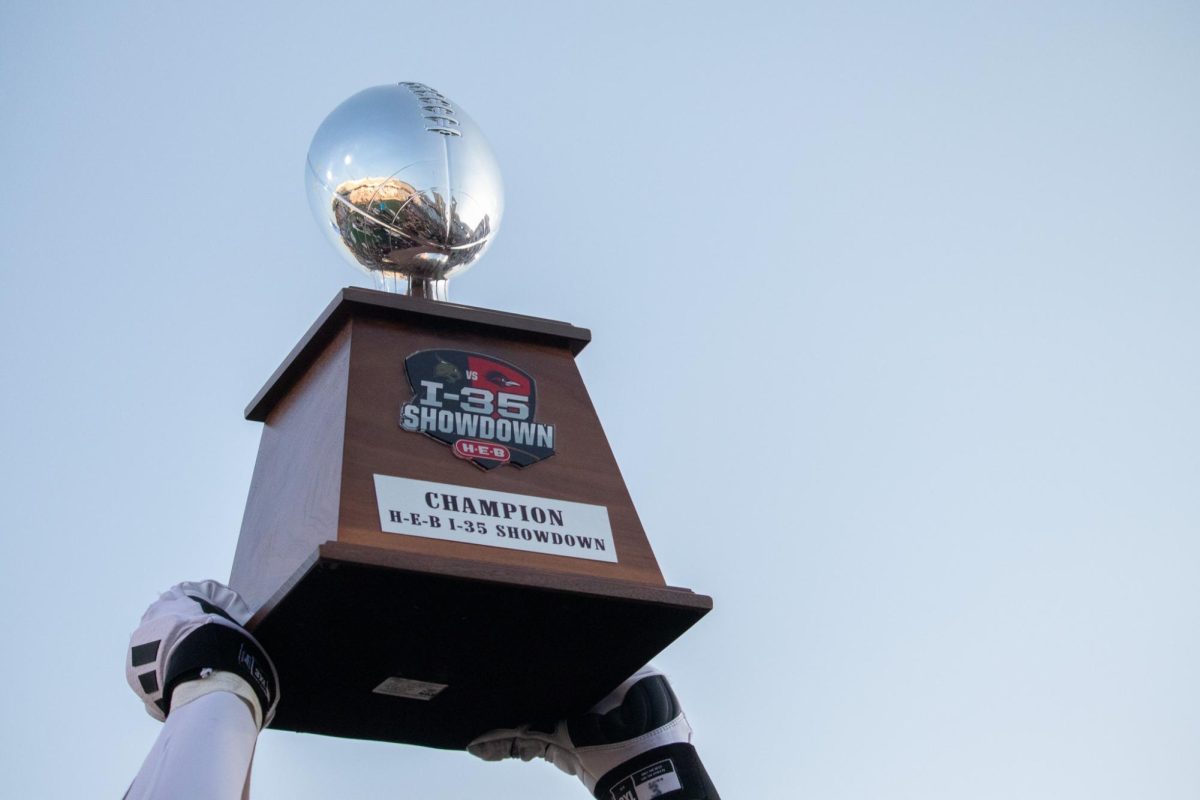 Texas State's Football team celebrates, holding the I-35 Showdown trophy after defeating UTSA, 49-10, Saturday, Sept. 7, 2024 at UFCU Stadium. The win marked the first time the Bobcats beat UTSA in their rivalry series.