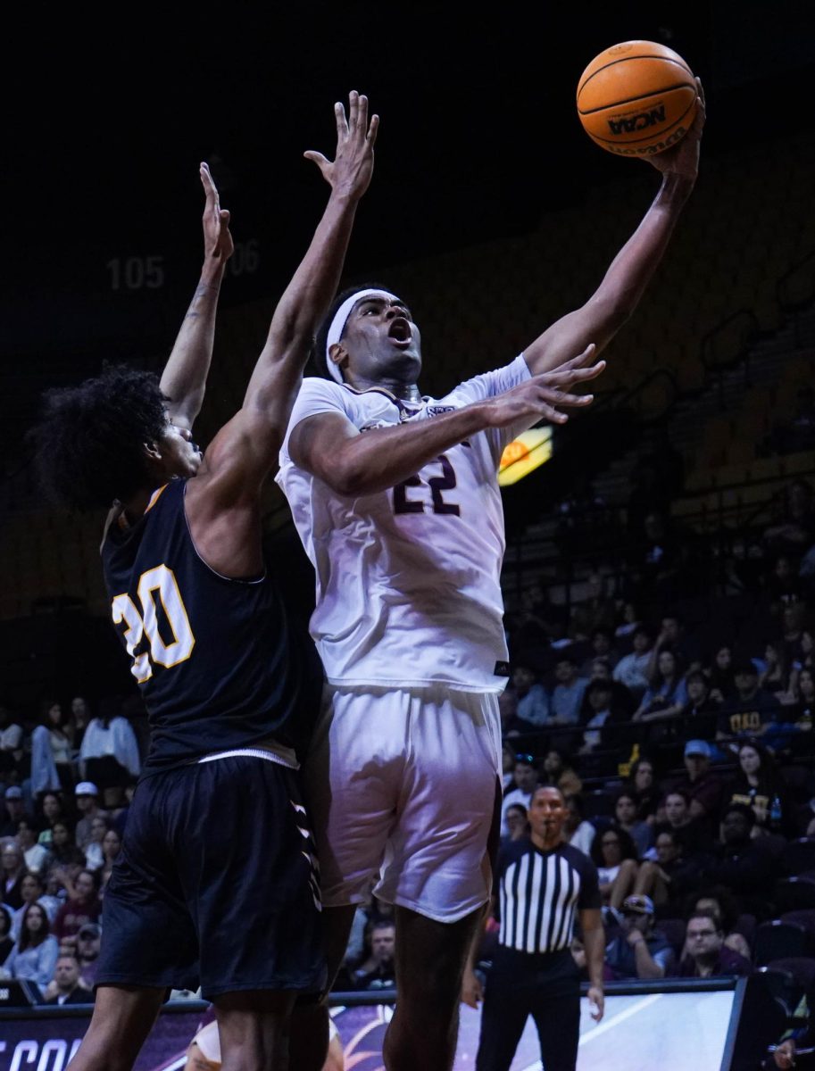 Texas State senior center Makai Willis attempts a layup over Texas Lutheran senior forward Darren Ford Jr., Monday, Nov. 24, 2025, at Strahan Arena.