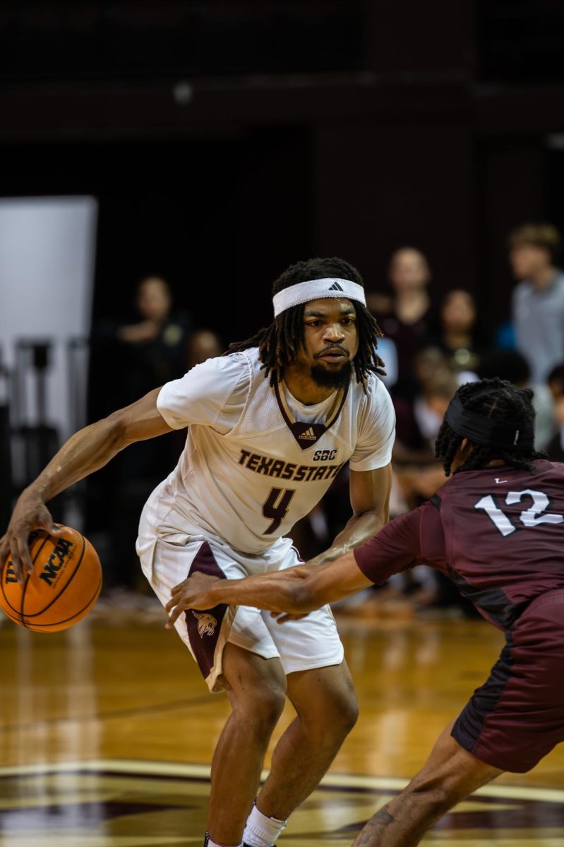 Texas State senior guard Mark Drone (4) dribbles the ball during the men's basketball game vs Little Rock Trojans, Friday, Nov. 21, 2025 at Strahan Arena. The Bobcats won 65-56.