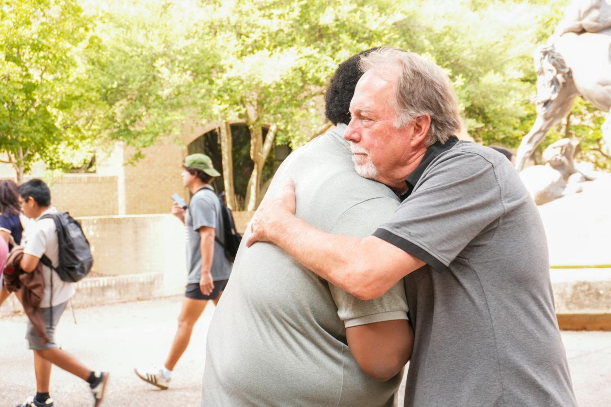 Texas State communication studies senior Devin Prophet (left) greets Pastor Jamie Bouzard (right) between classes, Wednesday, Nov. 19, 2025, at Texas State. Prophet said Bouzard helped him find his place on campus by leading him to Black student organizations.