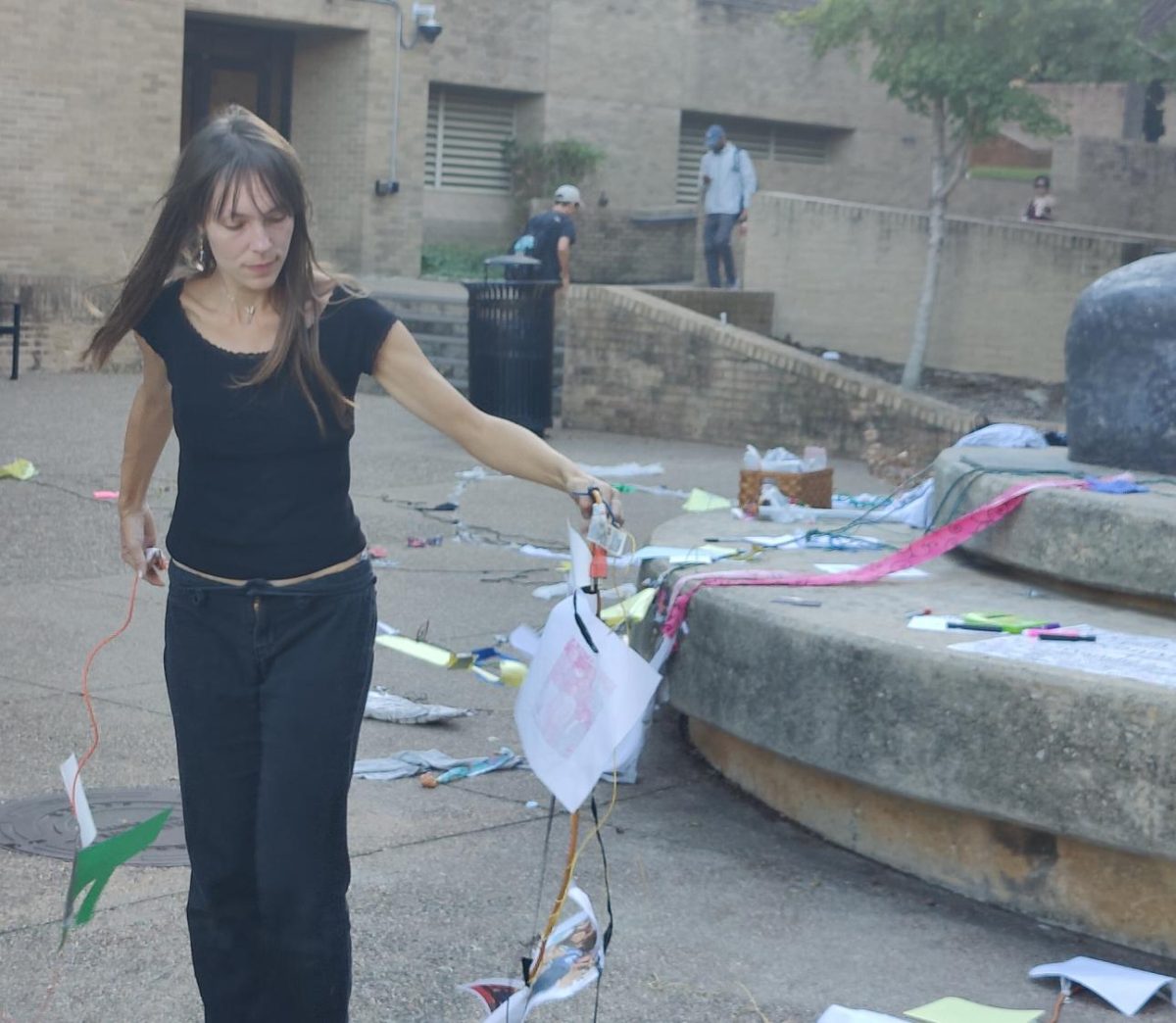 Assistant professor of instruction Jessamyn Plotts carries some of the tendrils of the collage feedback loop she facilitated for a photo, Wednesday, Nov. 5, 2025, at The Stallions on The Quad.