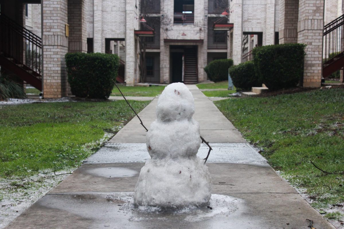 A snowman sits on the interior sidewalks of Bobcat Village Apartments, Sunday, Jan. 25, 2026, in San Marcos.