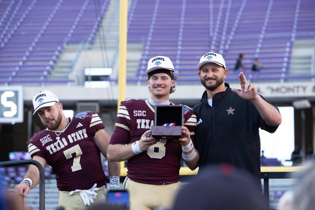 Texas State freshman quarterback Brad Jackson (8) celebrates after being named MVP in the Armed Forces Bowl, Friday, Jan. 2, 2025, at Amon G. Carter Stadium. Texas State won 41-10.