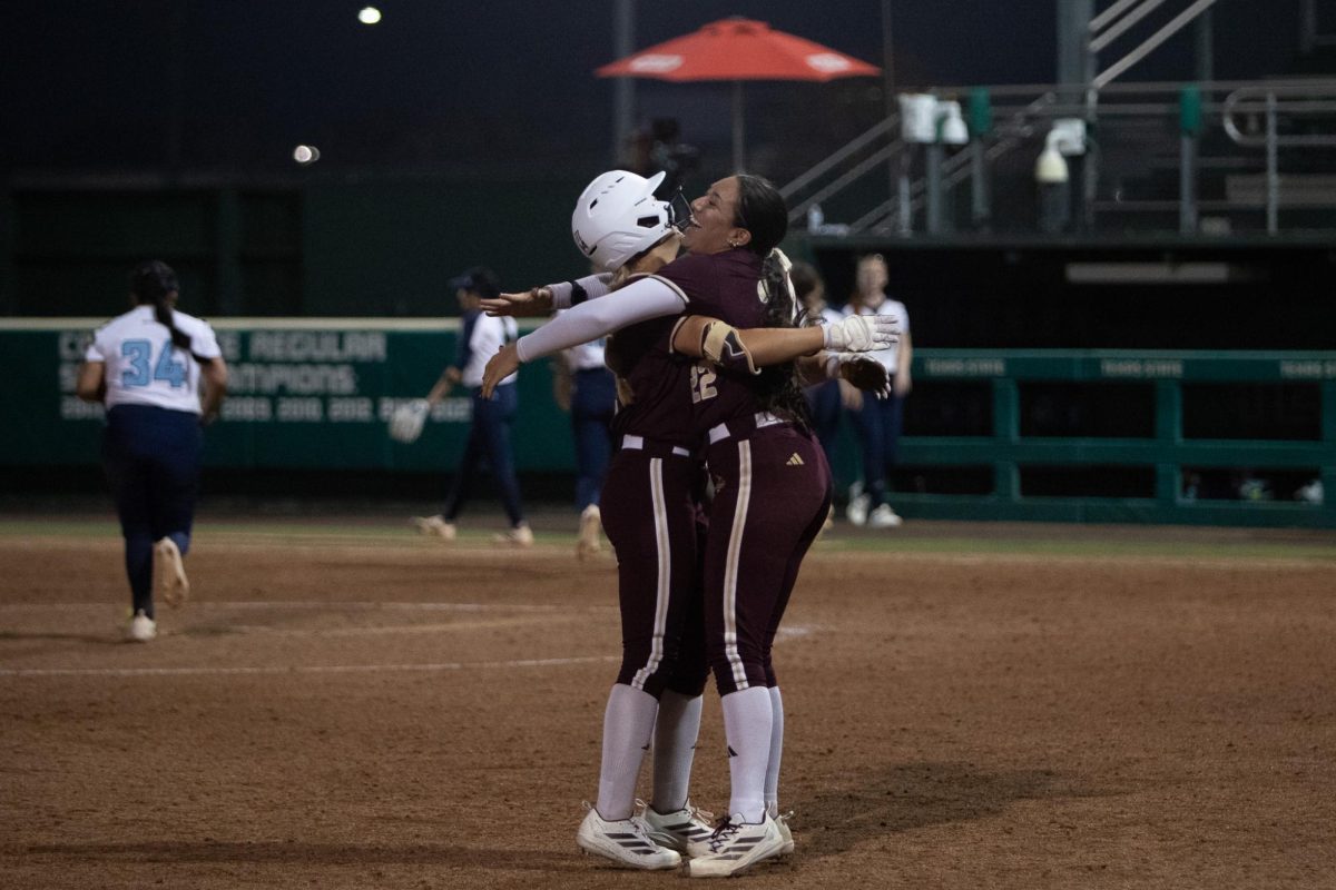 Texas State junior pitcher Madison Azua (22) celebrates with freshman outfileder Harley Vestal (12) after Vestal's walk-off against Kansas City, Thursday, Feb. 19, 2026, at Bobcat Softball Stadium. Texas State won 7-6.