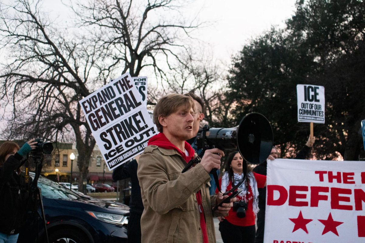 PSLSMTX member and San Marcos resident Matt Park leads chants during the “ICE out! National Day of Action” protests, Friday, Jan. 31, 2026, at the Hays County Courthouse. Protesters were on the square to encourage community members to walk out of work and school and boycott businesses.