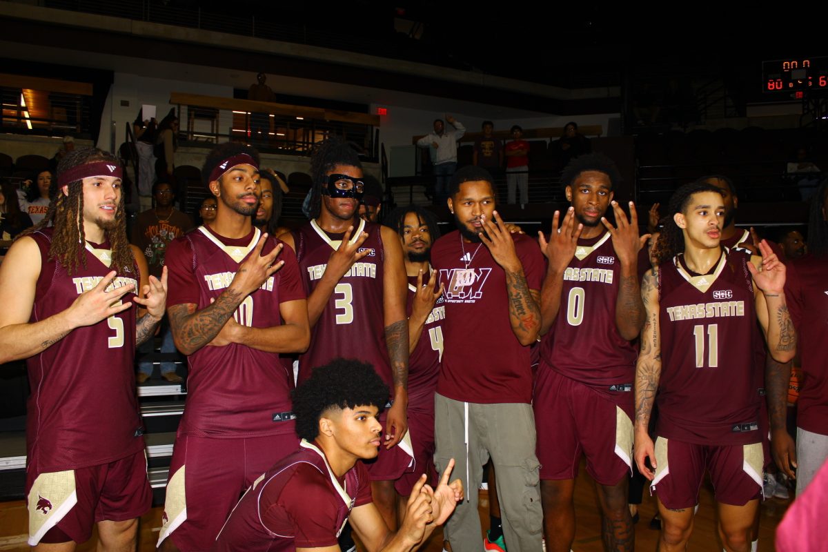 The Texas State basketball team poses for a photo after beating rival UTSA, Tuesday, Nov. 11, 2025, at Strahan Arena. Texas State won 80-69.
