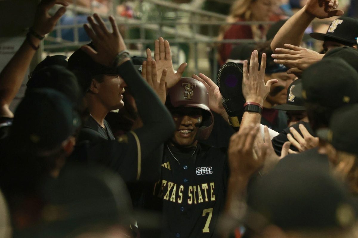 Texas State senior utility player Rashawn Galloway (7) crowded in the dugout against Abilene Christian, Friday, Feb. 27, 2026, at La Moderna Field in Cleburne, Texas. The Bobcats won 5-4.