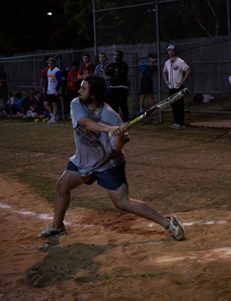 Texas State electronic media senior Sparti Locklin swings the bat during an intramural softball game Wednesday, Nov. 12, 2025, at the Bobcat Village Fields. 