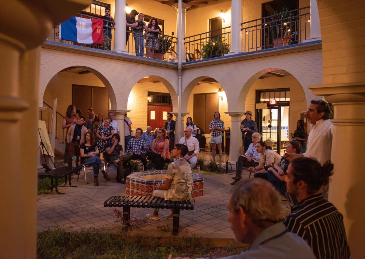 Community members gather to listen to a performance at the Night of Ideas, Friday, March 27, 2026, in the Taylor-Murphy Courtyard.