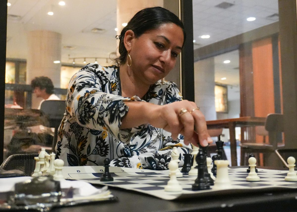 Texas State Chess Club adviser Susana Villanueva completes a turn, Thursday, March 5, 2026, outside Alkek Library. Chess club meets Wednesdays and Thursdays in Derrick Hall. 

