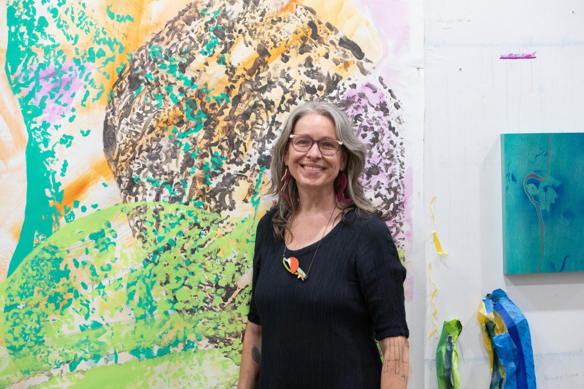 Multimedia artist Alicia Philley stands next to her untitled artwork during the San Marcos Studio Tour, Friday, April 3, 2026, at MotherShip Studios.