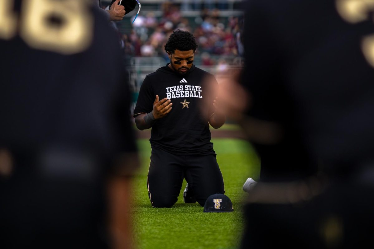 Texas State junior left fielder Jaquae Stewart (24) prays prior to first pitch against No.18 Texas A&M, Tuesday, April 7, 2026, at Irvine-Rasmussen Ballpark. The Bobcats beat the Aggies 9-8.