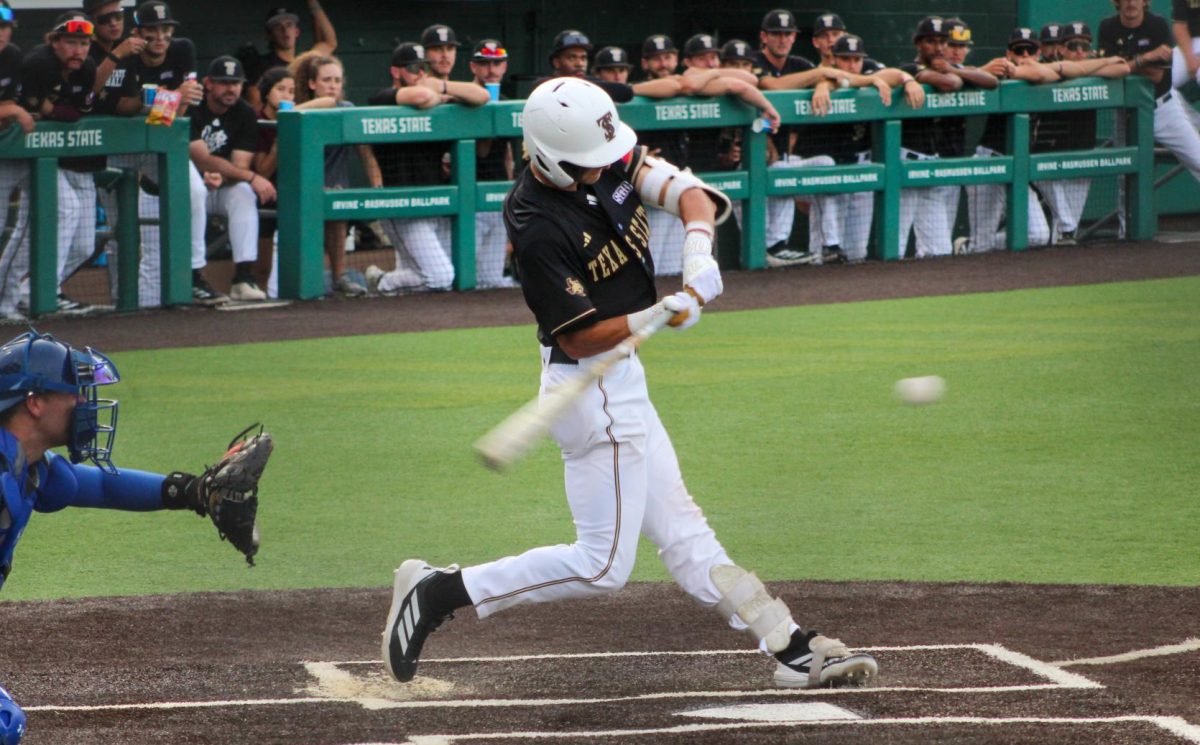 Texas State senior infielder Chase Mora (2) swings the bat, Tuesday, April 14, 2026, at Irvine-Rasmussen Ballpark. The Bobcats beat the Houston Christian Huskies 4-3.