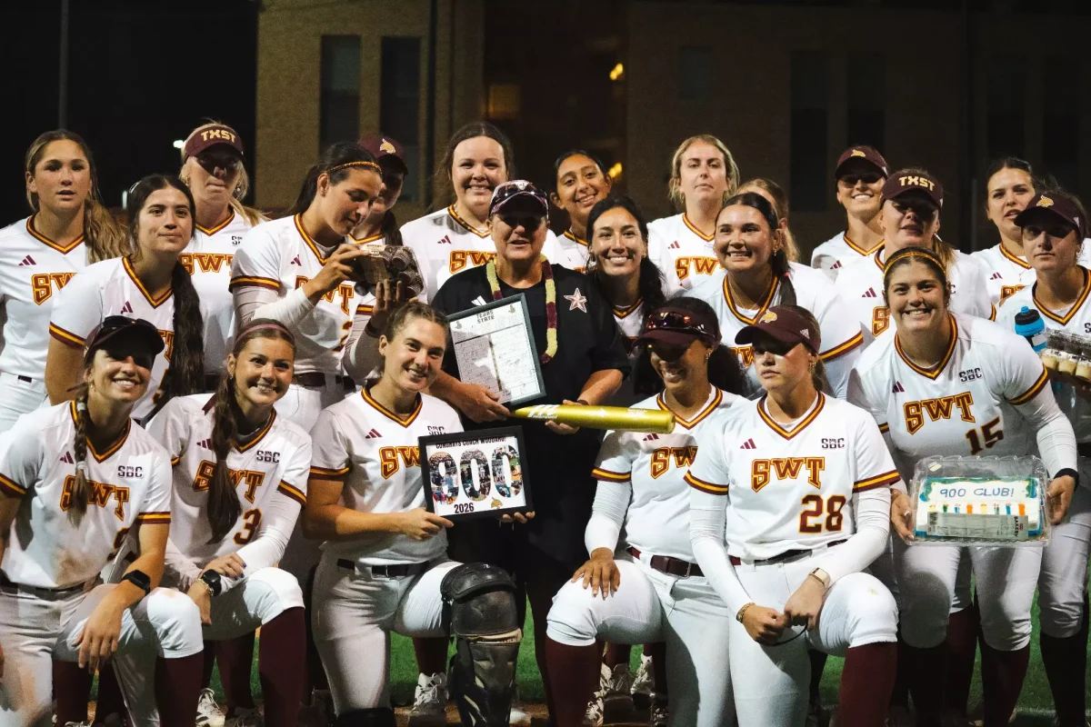 The Texas State softball team and head coach Ricci Woodard celebrate Woodard's 900th career after following an 8-1 victory over UTSA Tuesday, March 31, 2026, at Roadrunner field. 