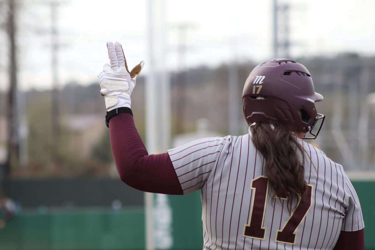 Texas State senior first basemen Aiyana Coleman (17) gives the "States Up" hand sign after a single, Friday, March 6, 2026, at Bobcat Softball Stadium. The Bobcats beat Texas A&M 3-1.