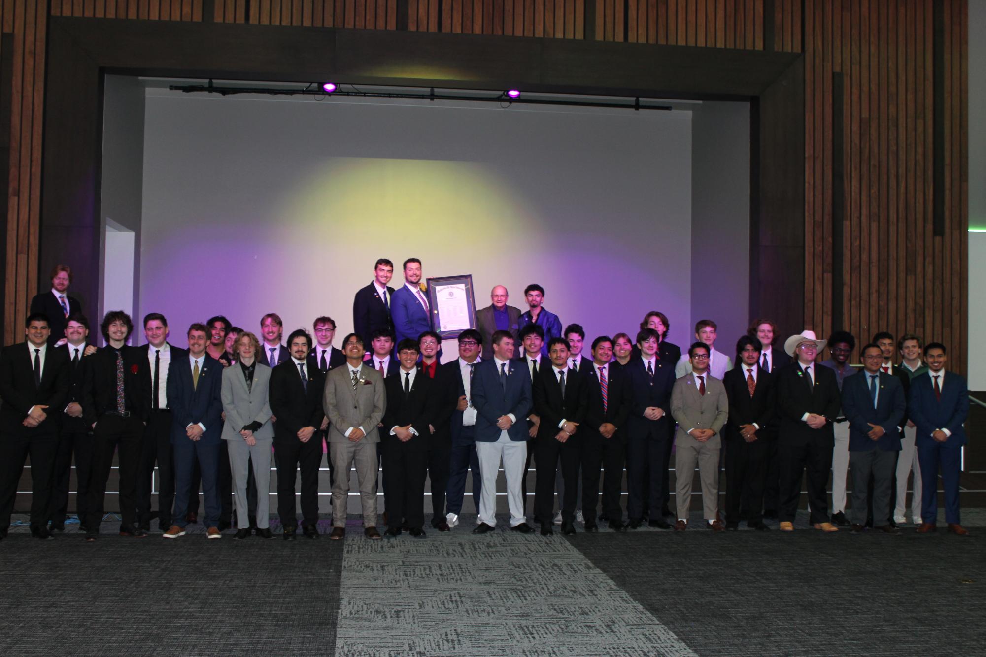 Members of Lambda Chi Alpha gather with their charter in the LBJ Ballroom in the LBJ Student Center on April 18, 2026.