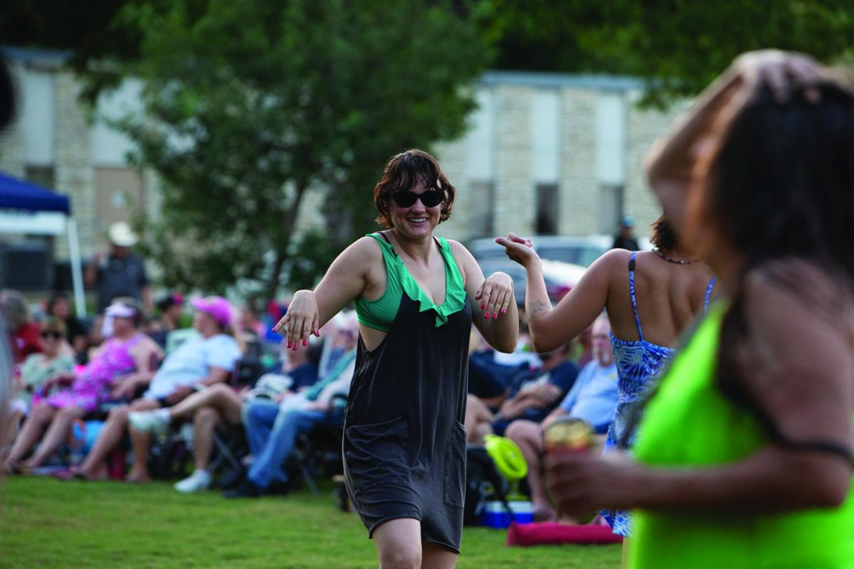 San Marcos residents dance to the music at the Summer in the Park concert, Thursday, June 18, 2026, at Plaza Park.